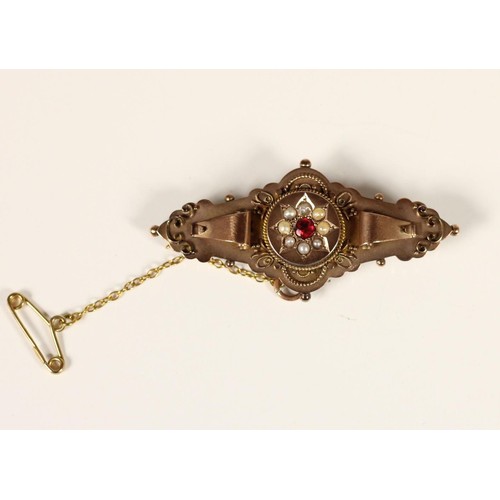 79 - An Edwardian 9ct rose gold panel brooch, Birmingham 1905, set with a red paste and half pearl cluste... 