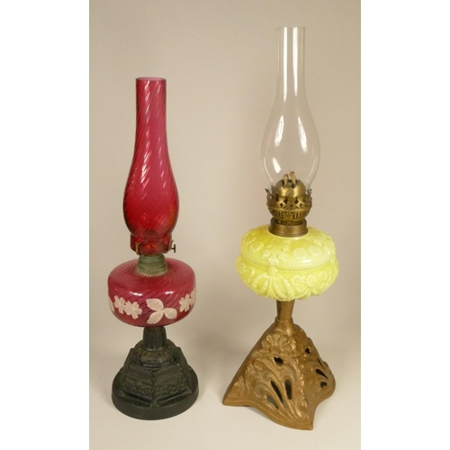 166 - A 19th century cranberry glass oil lamp, on a gilt metal base, 52 cm, together with a vaseline glass... 