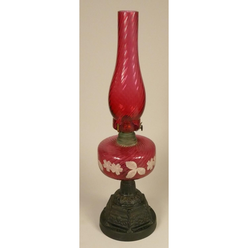 166 - A 19th century cranberry glass oil lamp, on a gilt metal base, 52 cm, together with a vaseline glass... 