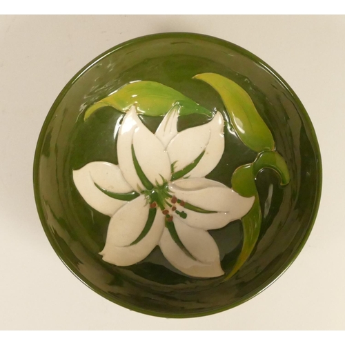 187 - A Moorcroft green glazed bowl with white lily, signed signature to base, 7 x 16 cm