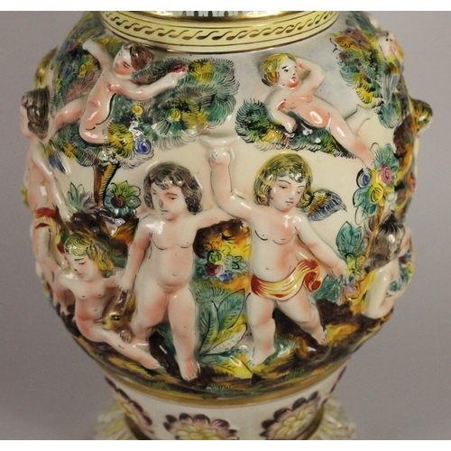 191 - A Capo de Monte lamp base with cherub details, signed to base, 429 Italy, 39 cm, together with two c... 