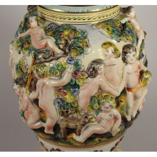 191 - A Capo de Monte lamp base with cherub details, signed to base, 429 Italy, 39 cm, together with two c... 