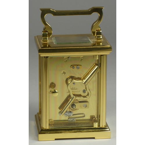 213 - A brass carriage clock, the enamel dial signed Woodford, Est 1860, Roman numerals, the movement sign... 