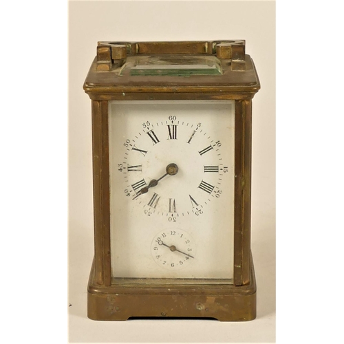 231 - A brass alarm carriage clock, the white enamel dial with subsidiary alarm dial, the movement strikin... 