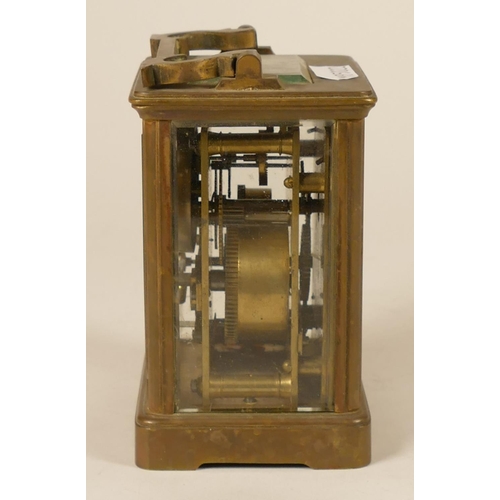 231 - A brass alarm carriage clock, the white enamel dial with subsidiary alarm dial, the movement strikin... 