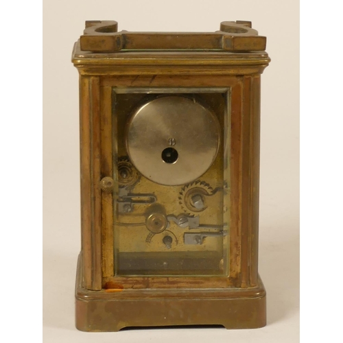 231 - A brass alarm carriage clock, the white enamel dial with subsidiary alarm dial, the movement strikin... 