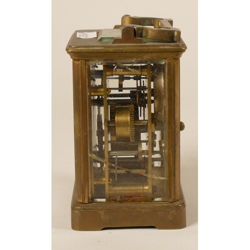 231 - A brass alarm carriage clock, the white enamel dial with subsidiary alarm dial, the movement strikin... 