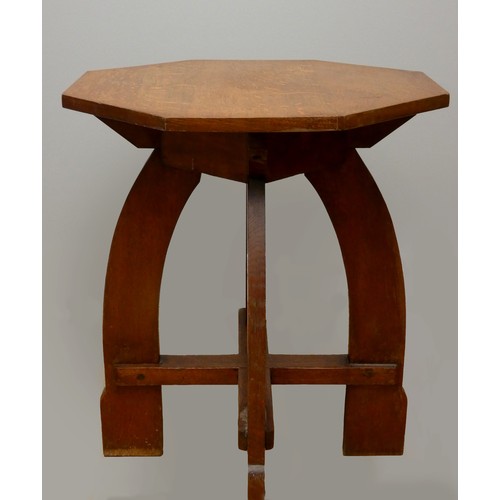 249 - An Arts & Crafts oak side table, octagonal shaped top with lower cross member, raised on four curved...