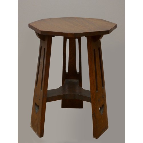 252 - An Art Nouveau Liberty oak side table, with octagonal top on three heart pierced tapered legs.
40cm ... 