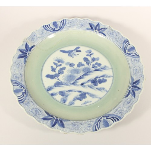 199 - A Kang Si blue and white charger, with central bird and foliage design, floral wavy boarder, charact... 