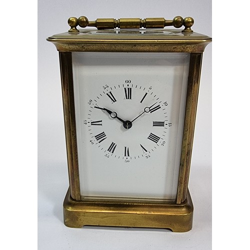 235 - A brass carriage clock, the white enamel dial with Roman numerals, the movement numbered 98, 13 x 10... 