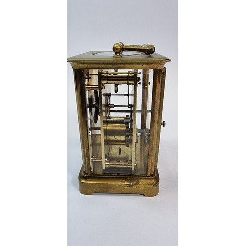 235 - A brass carriage clock, the white enamel dial with Roman numerals, the movement numbered 98, 13 x 10... 