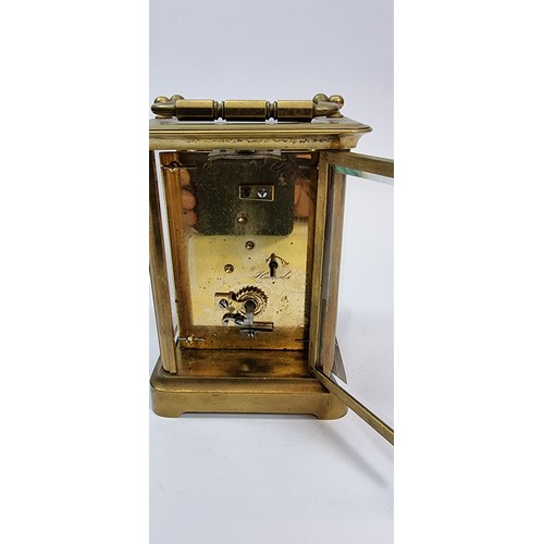 235 - A brass carriage clock, the white enamel dial with Roman numerals, the movement numbered 98, 13 x 10... 