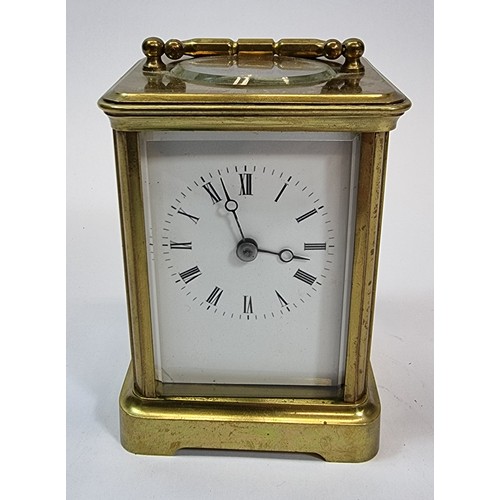 236 - A brass striking carriage clock, the white enamel dial with Roman numerals, the movement striking on... 