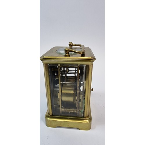 236 - A brass striking carriage clock, the white enamel dial with Roman numerals, the movement striking on... 