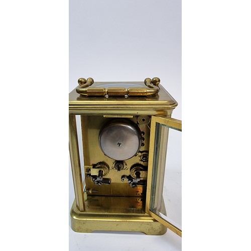 236 - A brass striking carriage clock, the white enamel dial with Roman numerals, the movement striking on... 