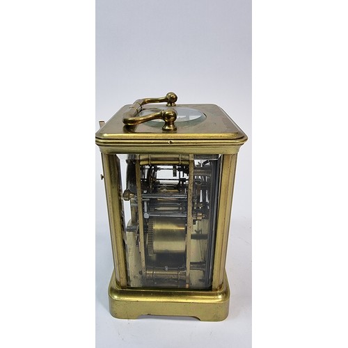 236 - A brass striking carriage clock, the white enamel dial with Roman numerals, the movement striking on... 