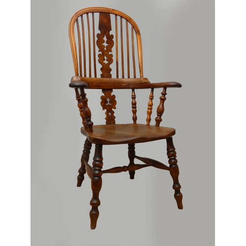 241 - A Victorian ash and elm Windsor armchair, with pierced vase splat, raised on turned legs, scroll arm... 