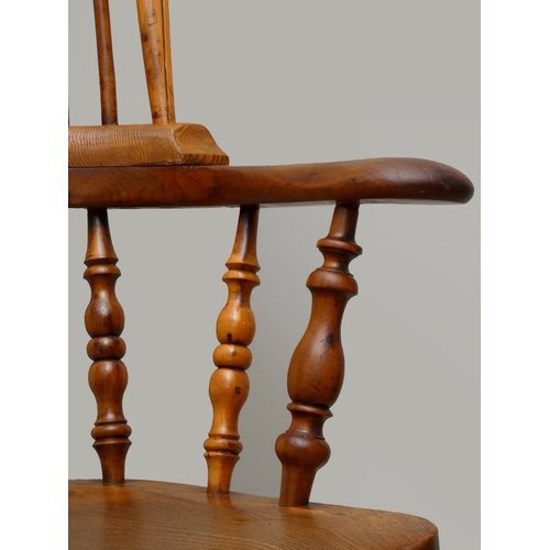 241 - A Victorian ash and elm Windsor armchair, with pierced vase splat, raised on turned legs, scroll arm... 