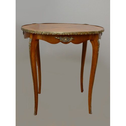 257 - A French kingwood, mahogany and ormolu oval side table, with quarter veneered top, applied mounts to... 