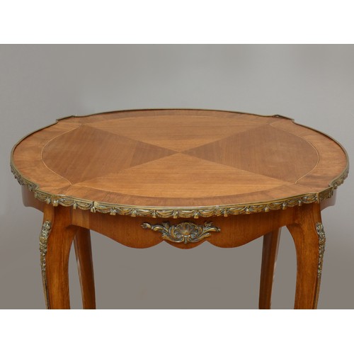 257 - A French kingwood, mahogany and ormolu oval side table, with quarter veneered top, applied mounts to... 