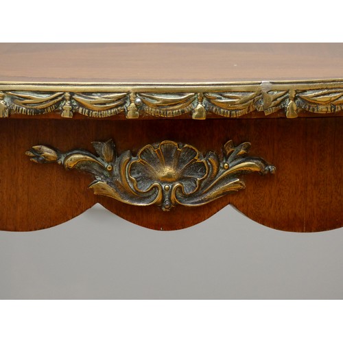 257 - A French kingwood, mahogany and ormolu oval side table, with quarter veneered top, applied mounts to... 