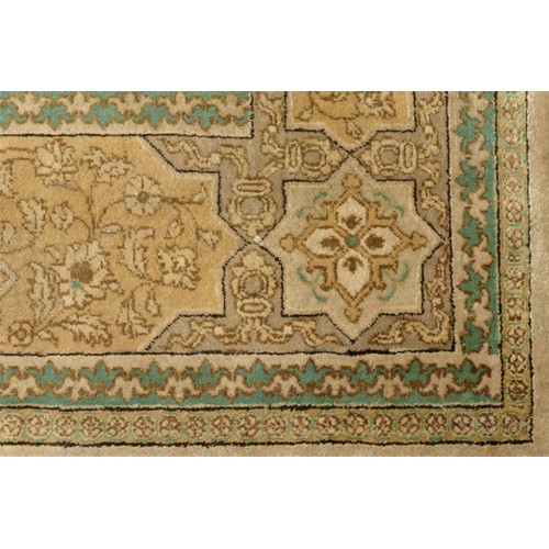 261 - A signed antique Persian rug, the pale gold and green geometric pattern field with outer border, sig... 