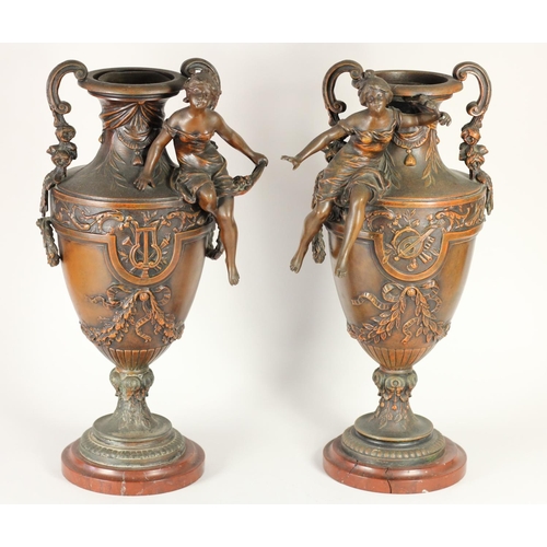 170 - A pair of spelter vases, mounted on red marble, two handles, decorative figures and floral designs, ... 