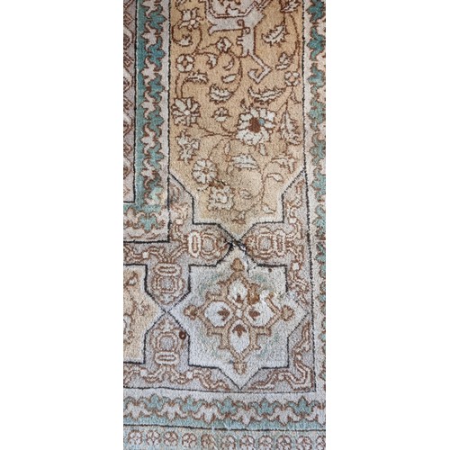 261 - A signed antique Persian rug, the pale gold and green geometric pattern field with outer border, sig... 