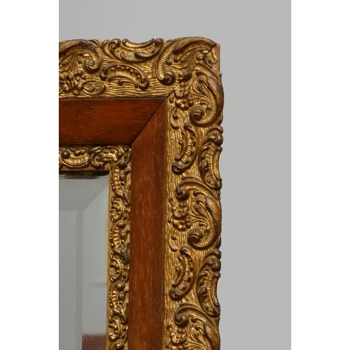 263 - An Edwardian carved giltwood and mahogany rectangular wall mirror, with bevelled edge glass, 113 x 5... 