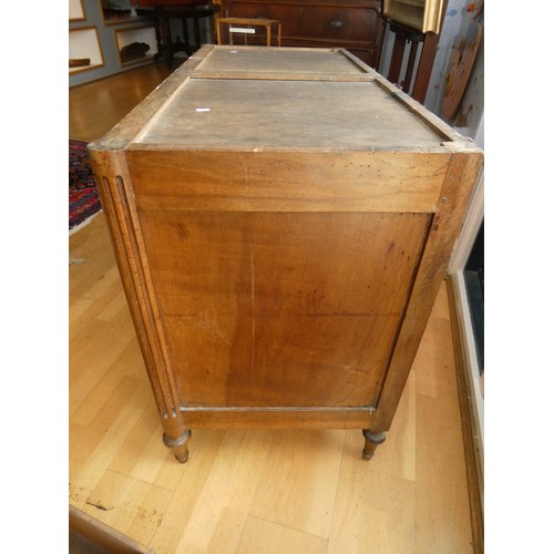 258 - A French walnut chest of three drawers, flanked by fluted columns, raised on tapering feet, grey mar... 