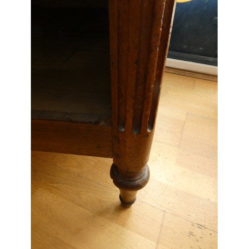 258 - A French walnut chest of three drawers, flanked by fluted columns, raised on tapering feet, grey mar... 