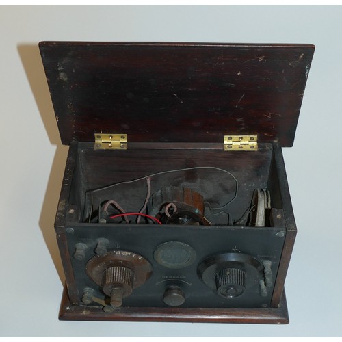 188 - A 1930's radio set in wooden case with black ebonite front. Brass valve heat vent,  