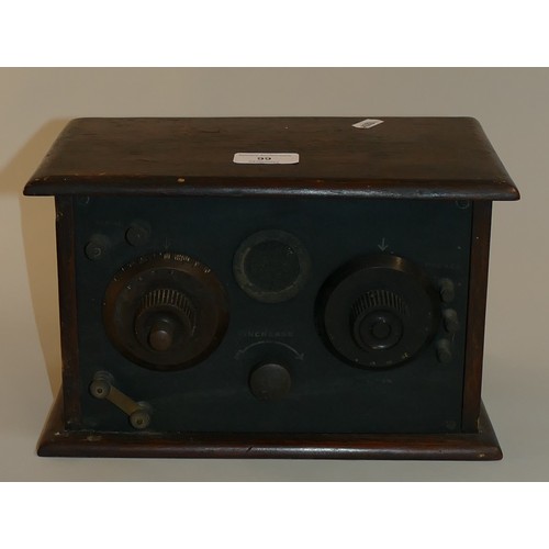 188 - A 1930's radio set in wooden case with black ebonite front. Brass valve heat vent,  