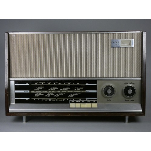 192 - A 1960's valve radio. FM, MW and LW. Checked and working. Tuning indicator. Wooden case, with feet a... 