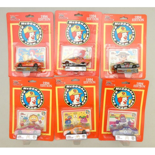 65 - A collection of 59 McDonalds Happy Meal toys, all in their original packaging, from the 80s and 90s,... 