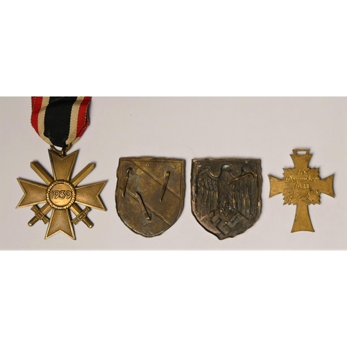 258 - WWII German Mother Cross in gold, Merit Cross with swords and tow Pith helmet badges