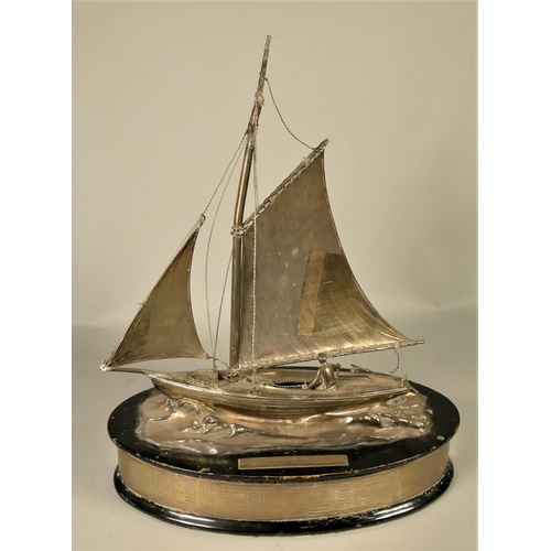 385 - An electoplated sailing presentation trophy, in the form of a gaff rigged, clinker built, vintage di... 