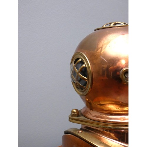 401 - A brass and copper novelty quartz desk clock, in the form of a divers helmet, wooden plinth, 19cm.