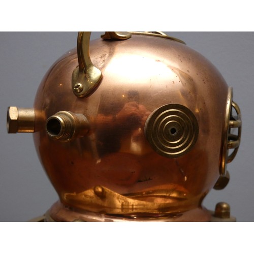 401 - A brass and copper novelty quartz desk clock, in the form of a divers helmet, wooden plinth, 19cm.