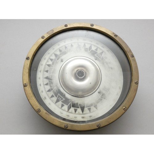 390 - A brass mounted ships compass, dial worn, diameter 25cm.