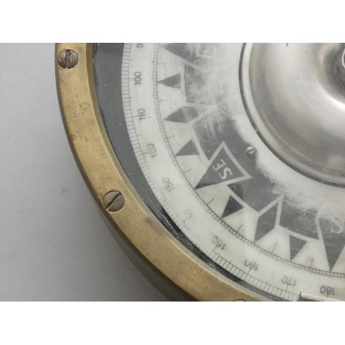 390 - A brass mounted ships compass, dial worn, diameter 25cm.