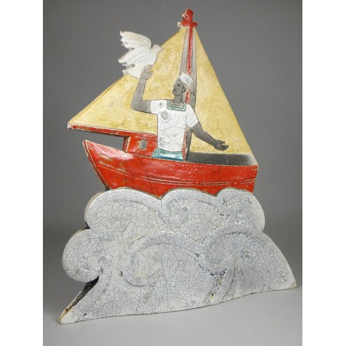 419 - Sarah Noel, a slab side and raku nautical figure of a sailor in a red sail boat, signed, 32cm