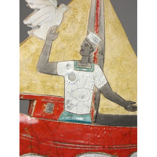 419 - Sarah Noel, a slab side and raku nautical figure of a sailor in a red sail boat, signed, 32cm