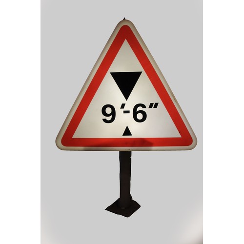 99 - A triangular illuminated road warning sign, depicting smaller than 9 ft 6 