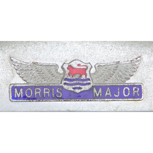 133 - A Morris Major chrome grill surround circa 1930, a Wolsey grill, together with a pair of Wolsey hub ... 