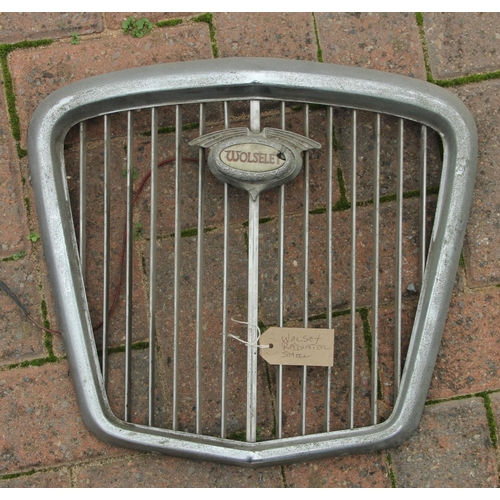 133 - A Morris Major chrome grill surround circa 1930, a Wolsey grill, together with a pair of Wolsey hub ... 