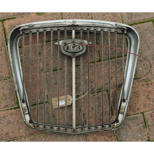 133 - A Morris Major chrome grill surround circa 1930, a Wolsey grill, together with a pair of Wolsey hub ... 