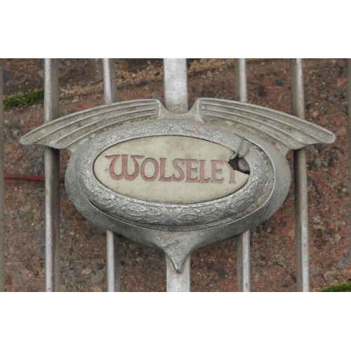 133 - A Morris Major chrome grill surround circa 1930, a Wolsey grill, together with a pair of Wolsey hub ... 