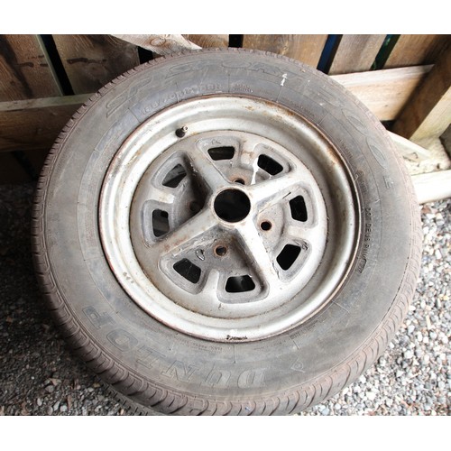 136 - A set of four MGB Rostyles wheels with assorted tyres